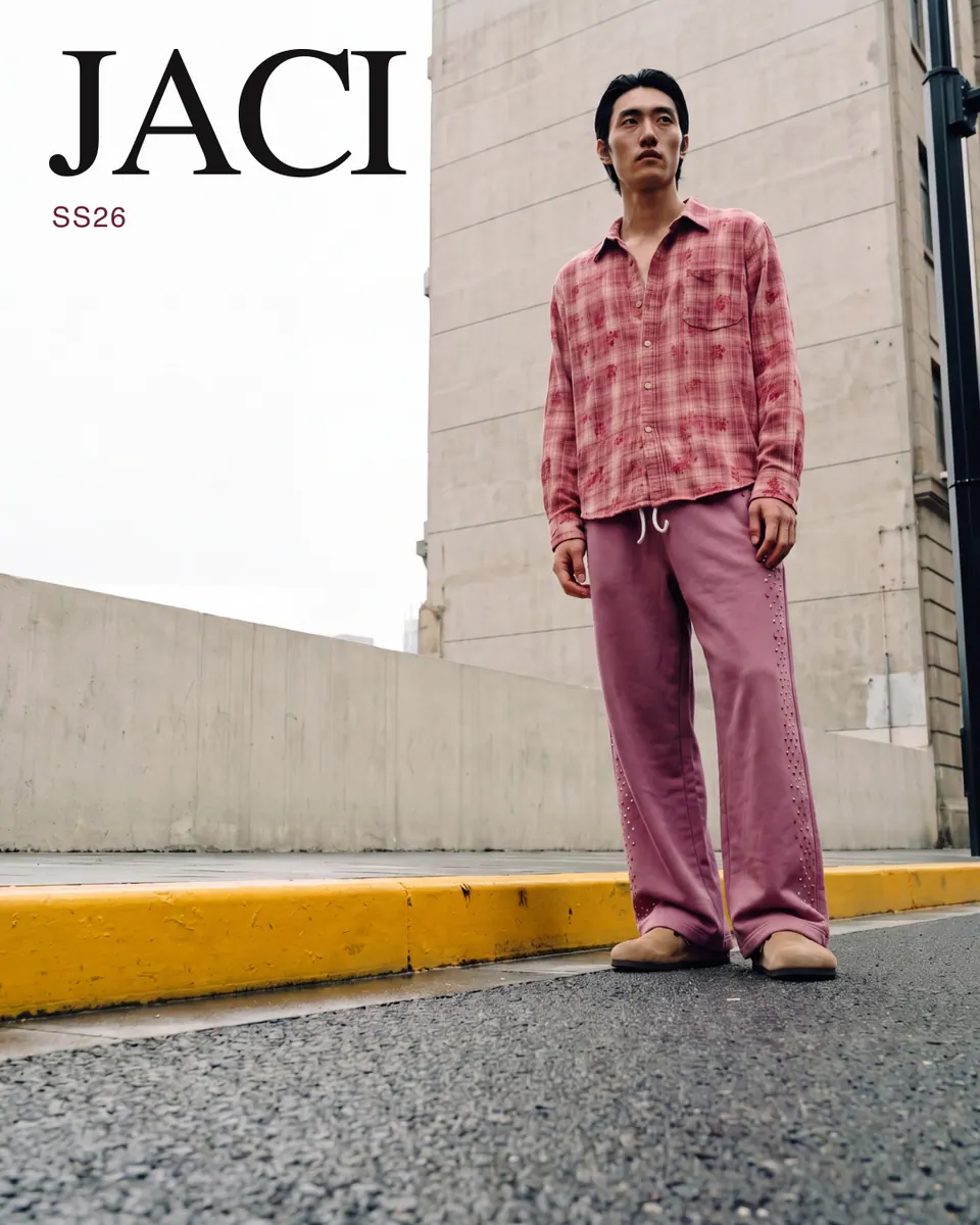 JACI ad: full-bleed low-angle frame beside a concrete building.
