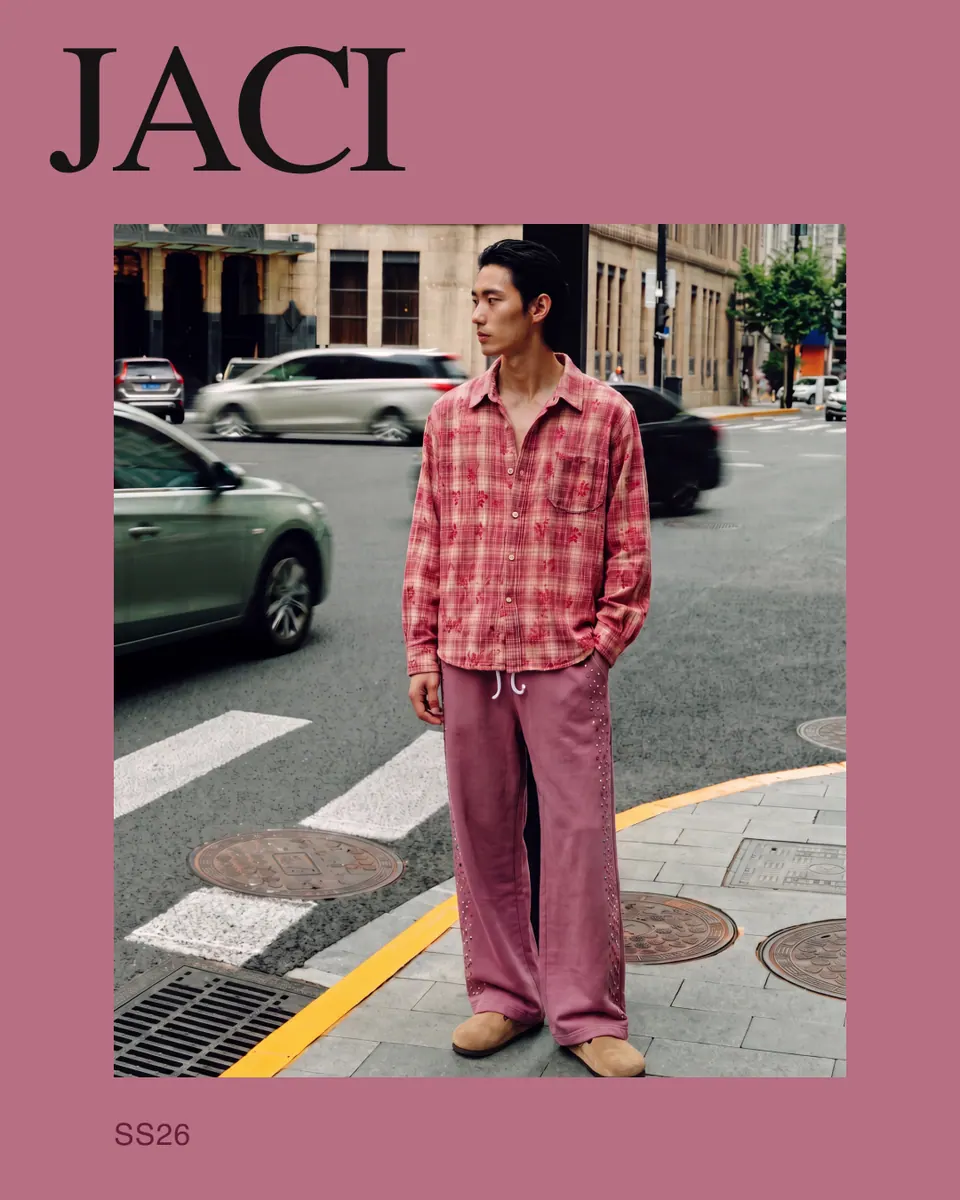 JACI ad: the street-corner frame set inside a pink border under the JACI masthead.