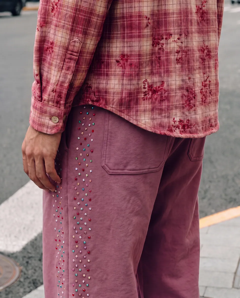 Close crop of the trouser pocket and crystal seam.
