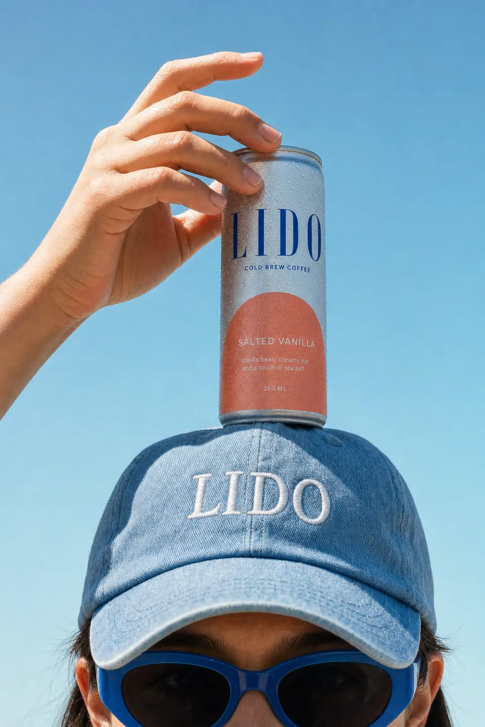 The same pose with a LIDO Salted Vanilla can balanced on the cap.