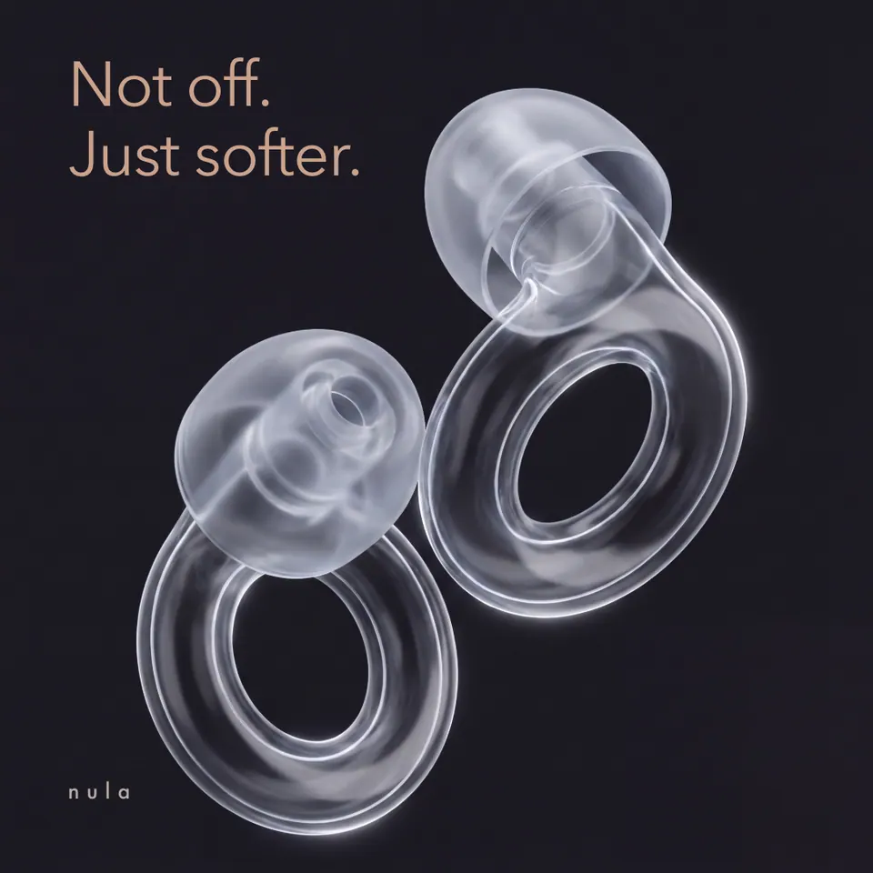 Nula ad: "Not off. Just softer." over translucent earplugs on black.